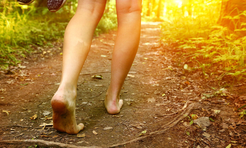 bare feet walking on the forest path